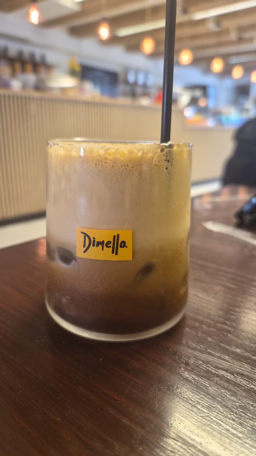 Dimello freddo espresso on a dark wood table